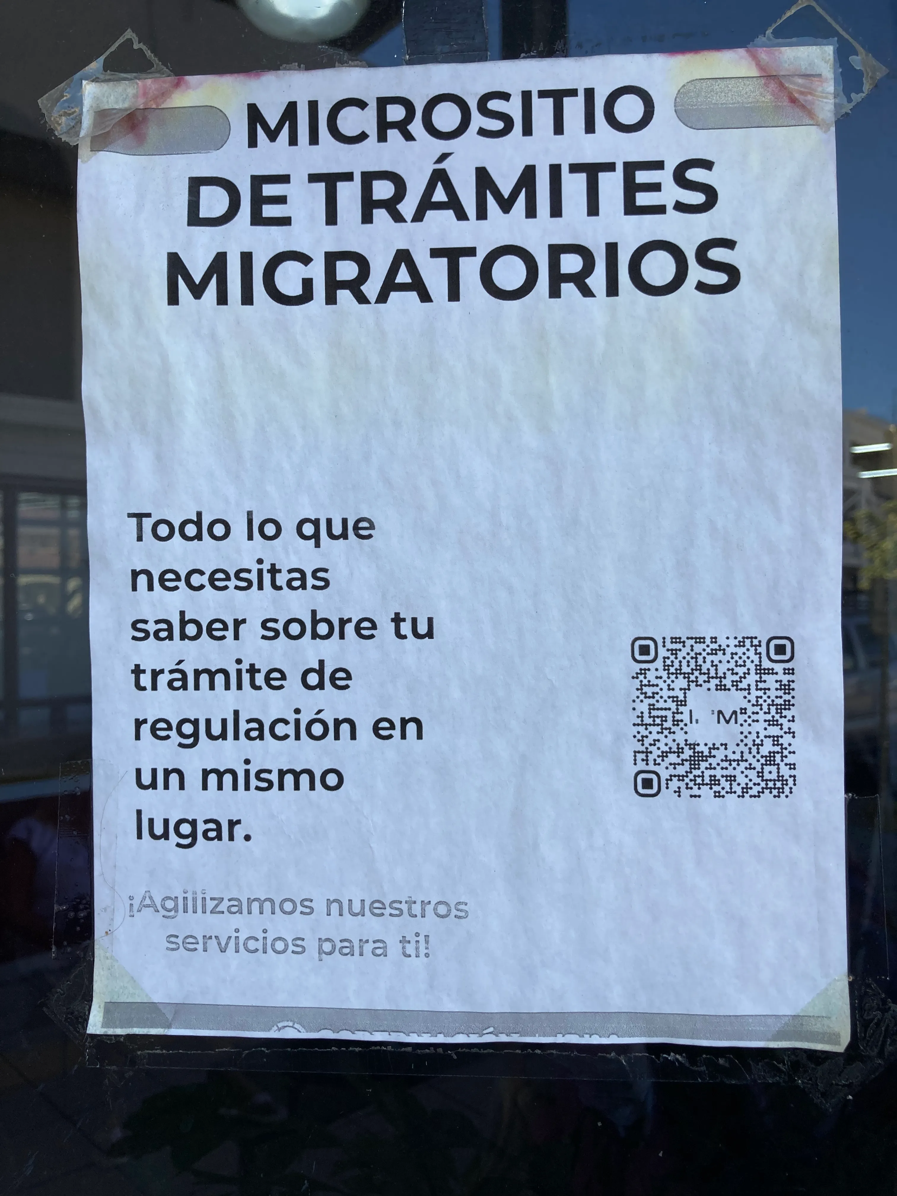 Sign on the front of the INM office door with QR code link to the micrositio